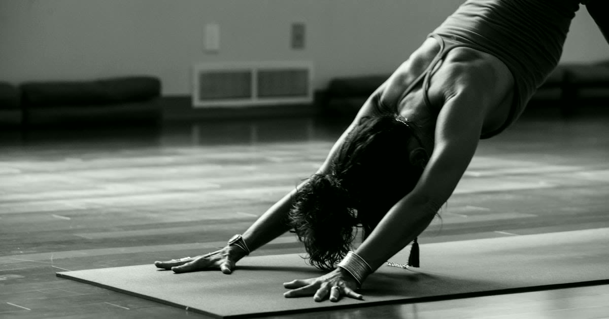 Pregnant woman practicing prenatal yoga at home
